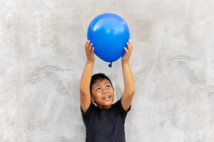 Boy plays with balloon