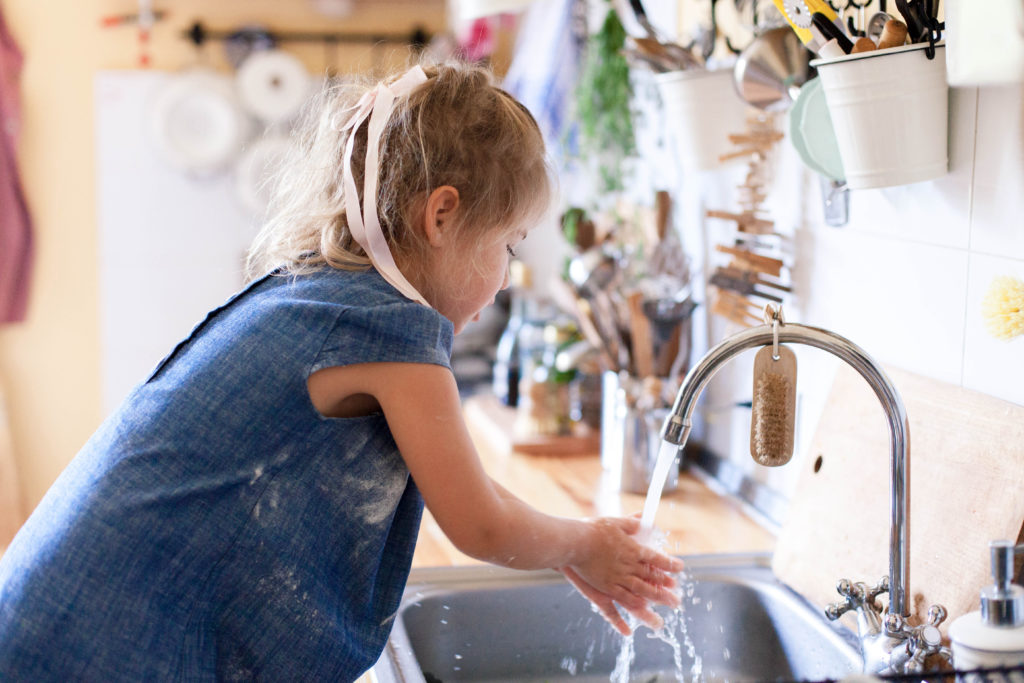 kid-washing-hands-at-home-under-water-tap-child-girl-in-flour-after-cooking-in-cozy-home-kitchen