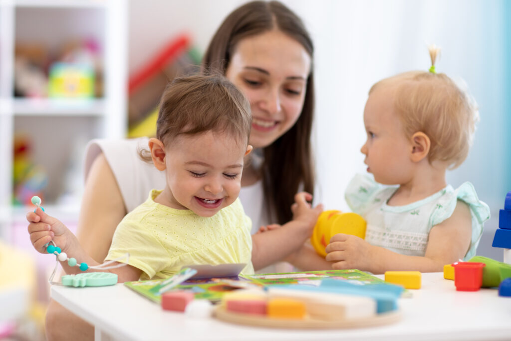 Teacher helps infants learn in a daycare.