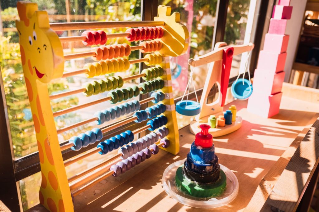 an abacus and other daycare supplies on a shelf at a child care center