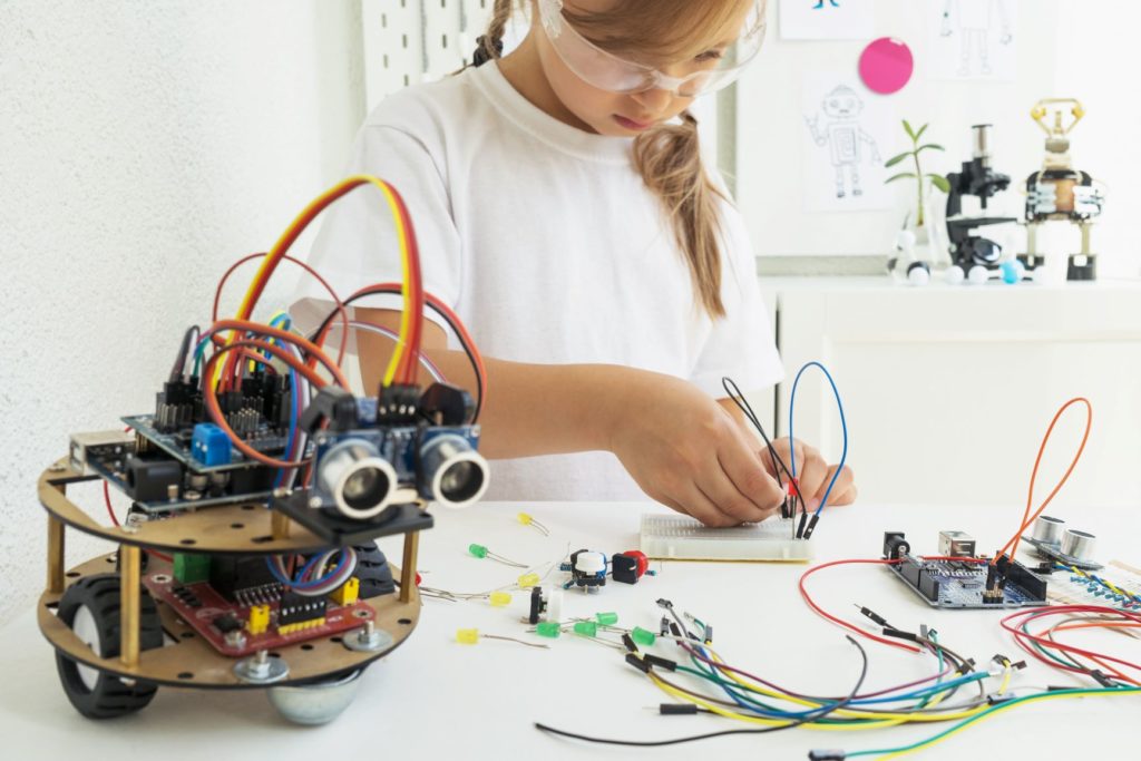 a young child working on a robotics project