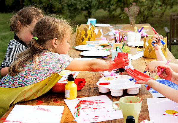 Preschoolers paint an art project.