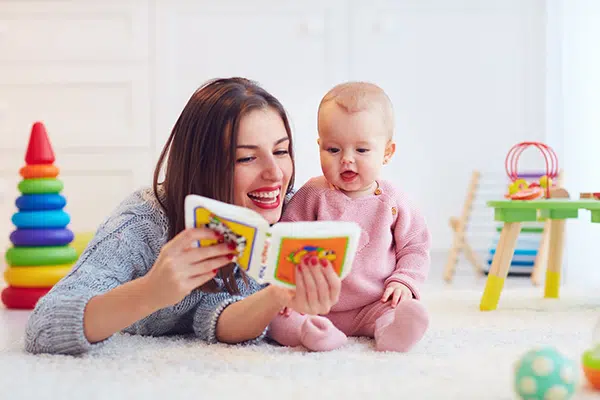 Teacher reads to an infant.