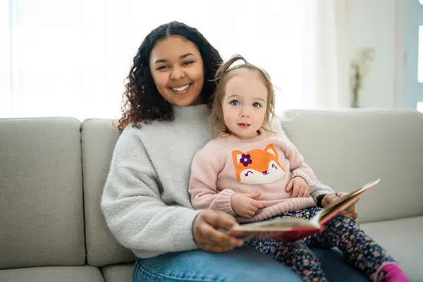 Teacher reads to a toddler.