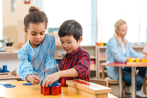 Preschool students play at learning centers.