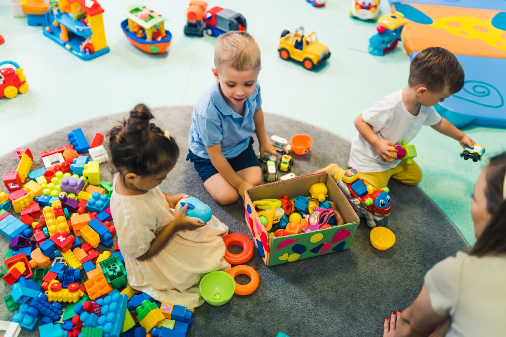 Children play with toys in a play center.