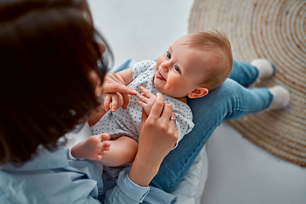 Baby smiles at caregiver.