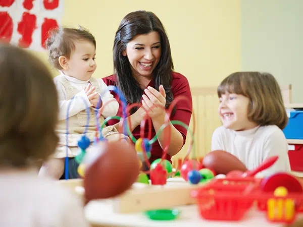 Teacher working with toys in daycare